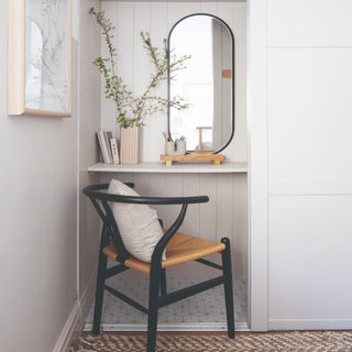 A bedroom nook dedicated to a home office space that doubles as a dressing table