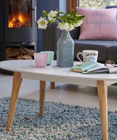 coffee table with flower on bottle and books