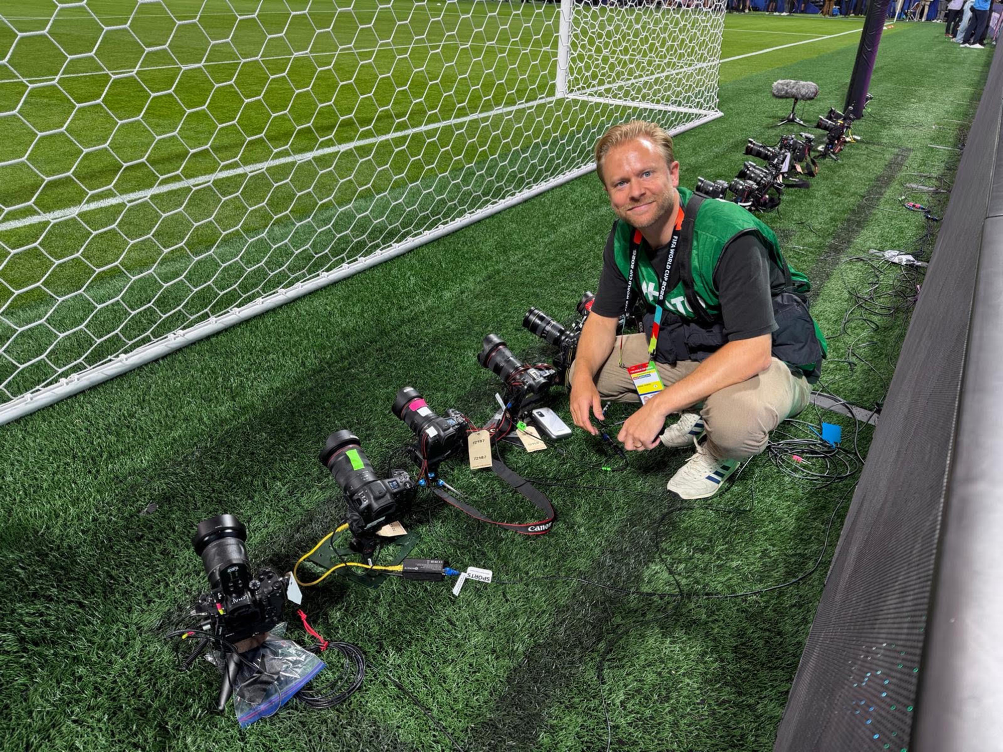 Joel Marklund setting up a remote camera behind a goal