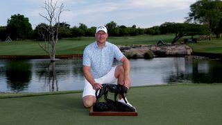 Shaun Norris poses with the 2024 Alfred Dunhill Championship trophy at Leopard Creek