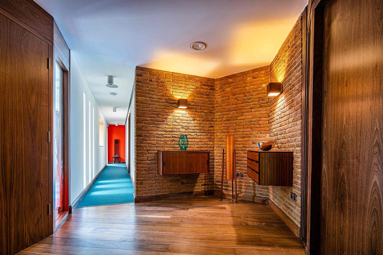 Inside the bungalow with a corridor to the left of the image
