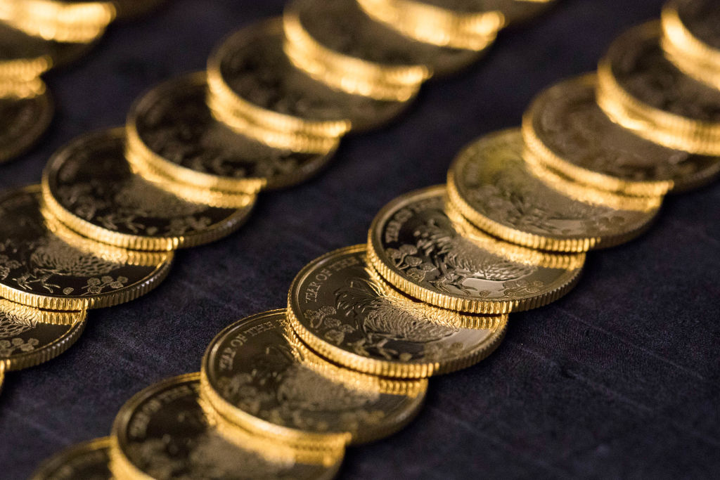 Gold bullion coins sit on a conveyor belt at The Royal Mint in Llantrisant, U.K.