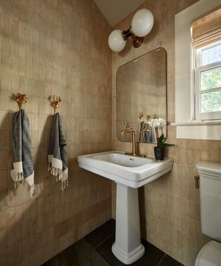 A tiled bathroom with a white sink