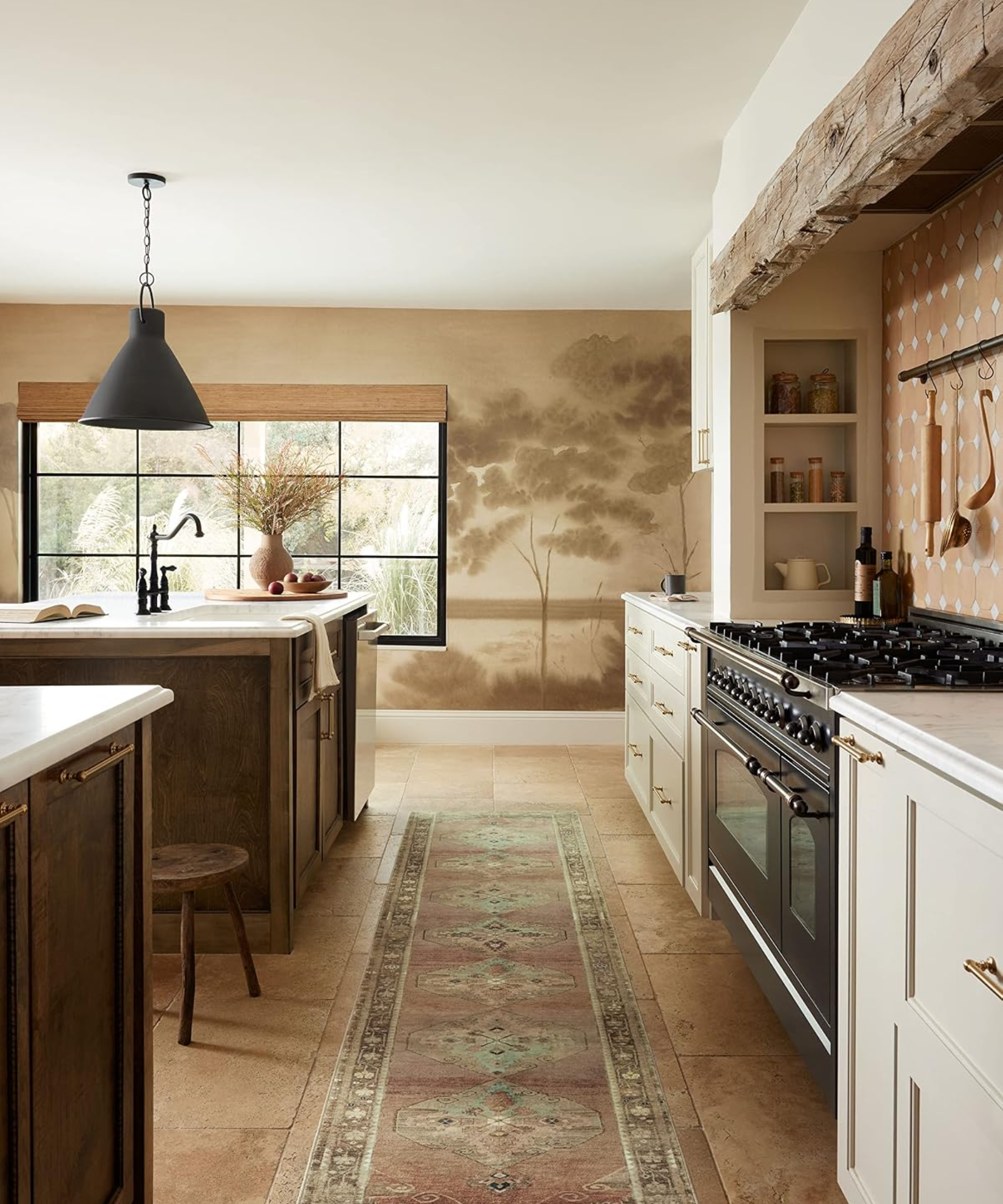 Antique-style patterned rug lining the tiled floor of a charming kitchen area, which features a glossy black stove, rustic wooden stool, and neutral nature murals decorating the walls.