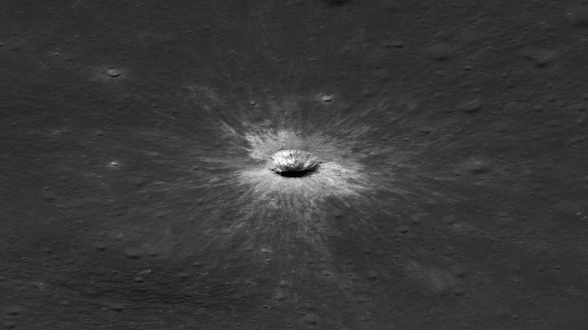 A black and white image of a clear, round crater.