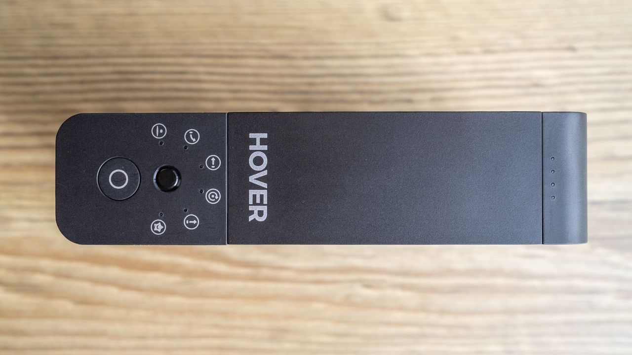 a black strip of plastic with a button and icons