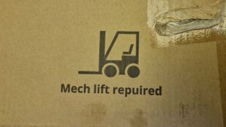 Photograph of the Fezibo Executive B standing desk packaging showing a forklift.