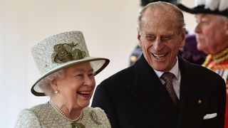 Queen Elizabeth II and Prince Philip, Duke of Edinburgh smile during a ceremonial welcome