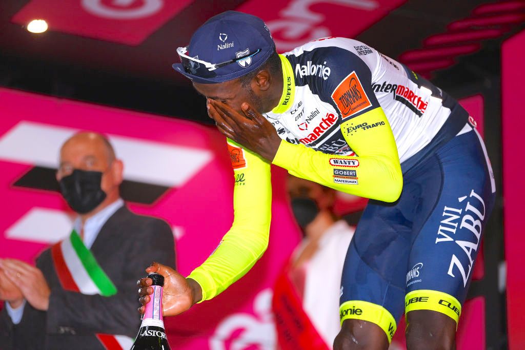 JESI, ITALY - MAY 17: Hailu Biniam Girmay of Eritrea and Team IntermarchÃ© - Wanty - Gobert MatÃ©riaux the stage winner after having an accident with the Astoria champagne stopper on the podium ceremony after the 105th Giro d&#039;Italia 2022, Stage 10 a 196km stage from Pescara to Jesi 95m / #Giro / #WorldTour / on May 17, 2022 in Jesi, Italy. (Photo by Tim de Waele/Getty Images)