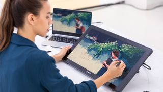 Woman drawing with one of the best Huion drawing tablets