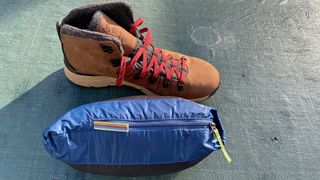 Kathmandu Heli R Down Jacket in size comparison with hiking boot