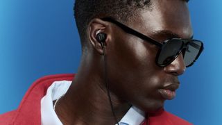 Bose Noise Cancelling Wired Earbuds on man with sunglasses and red fleece
