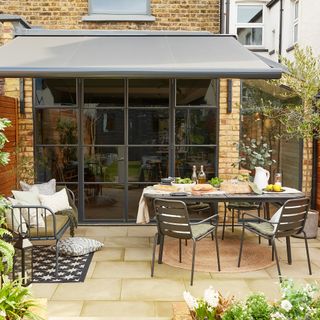 Terrace with awning above Crittal doors