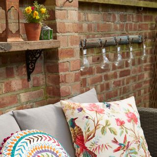 outdoor wall lighting with brick wall and cushions