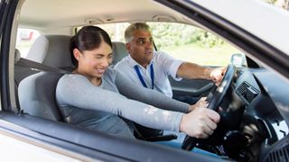 Scared girl having driving lesson