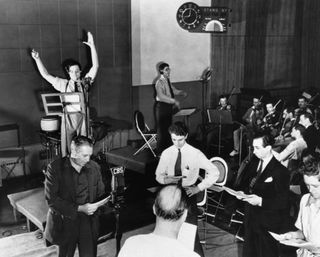 Orson Welles rehearsing a radio broadcast of H.G. Wells' classic, The War of the Worlds on October 10, 1938. The broadcast, which claimed that aliens from Mars had invaded New Jersey, terrified thousands of Americans. 