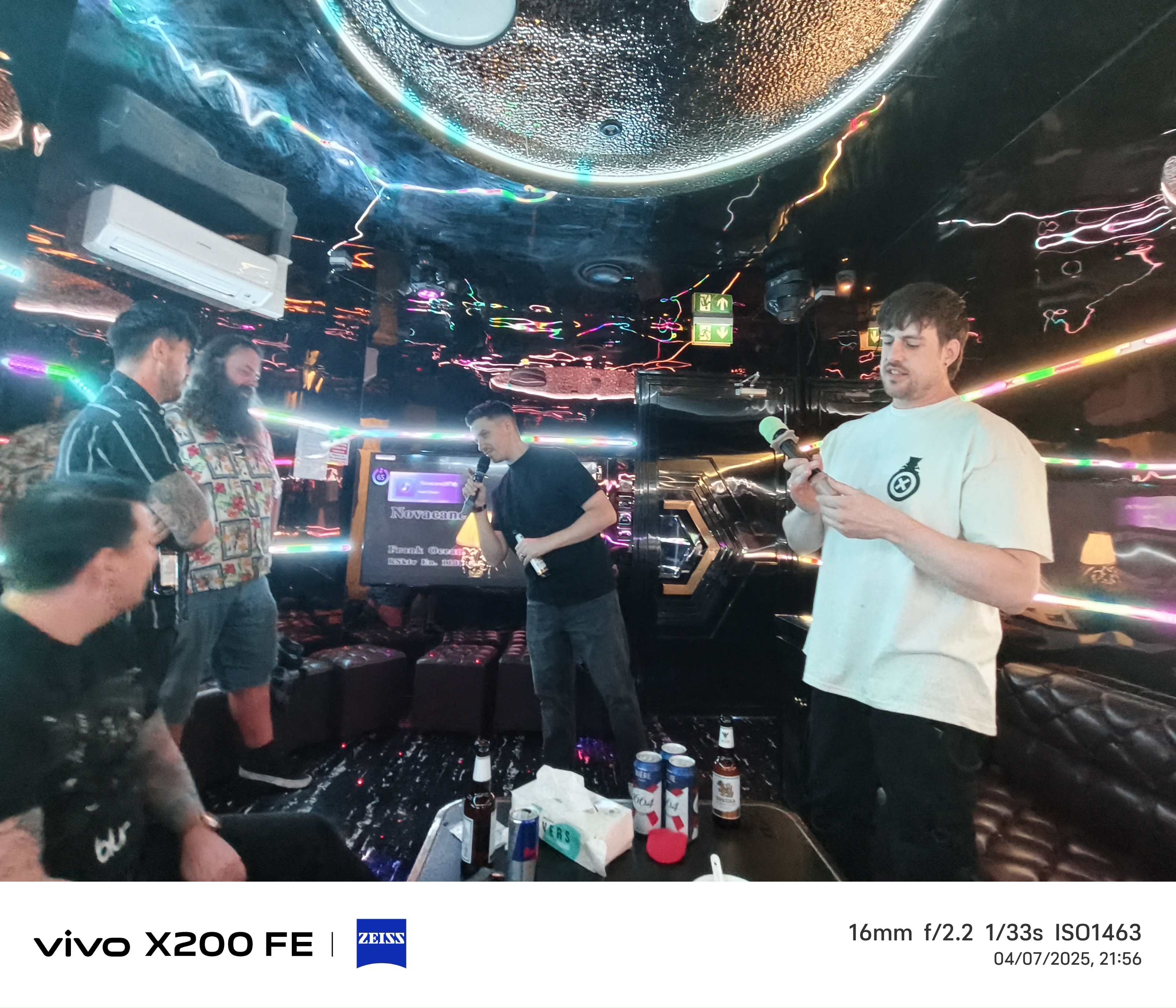 Group of friends doing karaoke in a bar