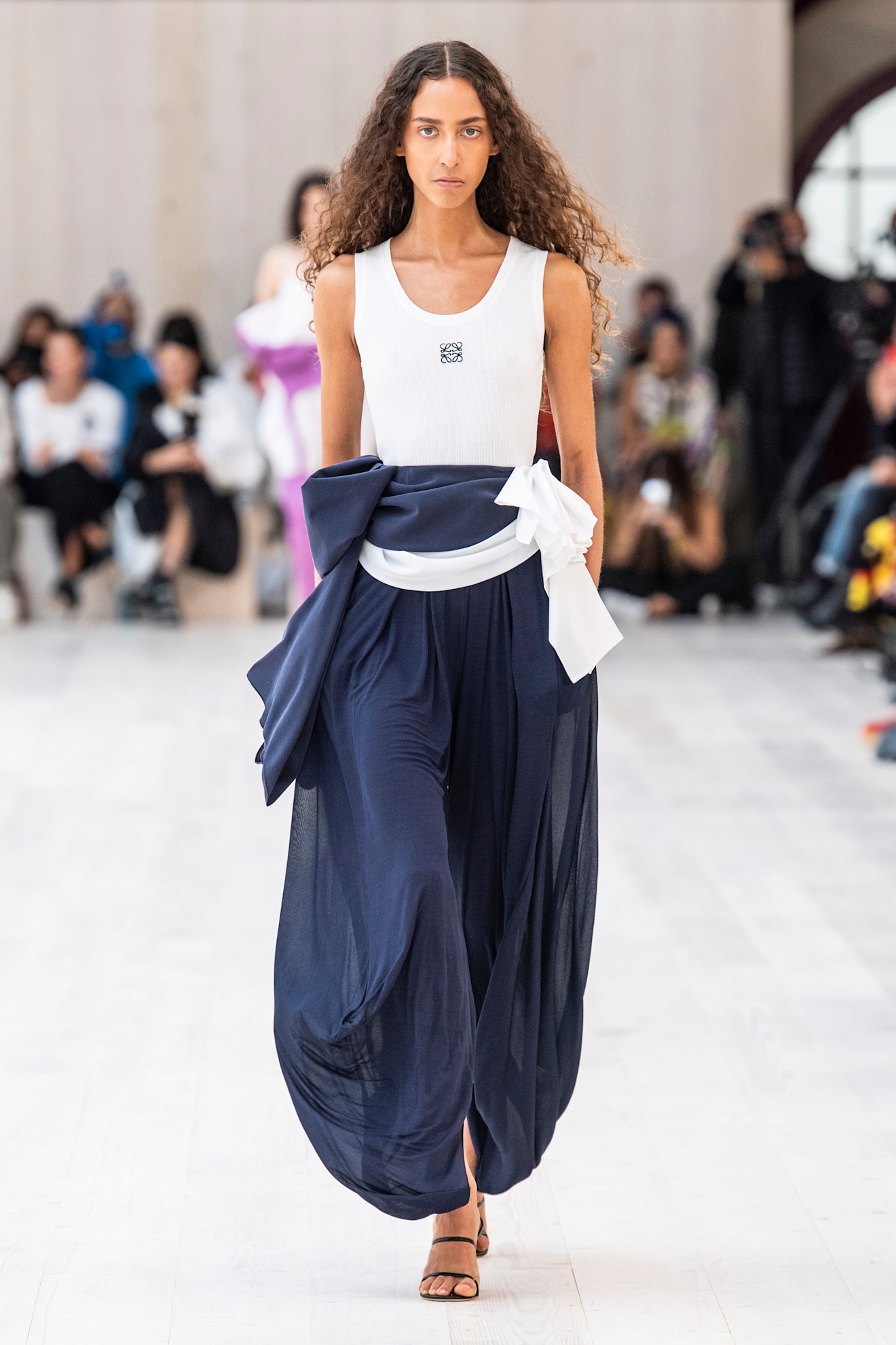 An image of a white tank top on Loewe's Spring/Summer 2022 runway.