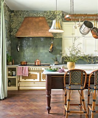 English kitchen with whimsical wallpaper, freestanding island and wood floor
