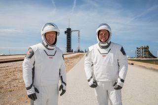 NASA astronauts Doug Hurley (at left) and Bob Behnken (right) participate in a dress rehearsal for their launch at the agency's Kennedy Space Center in Florida on May 23, 2020, ahead of SpaceX's Demo-2 mission to the International Space Station. The astronauts' SpaceX-designed spacesuits omit a mission patch.