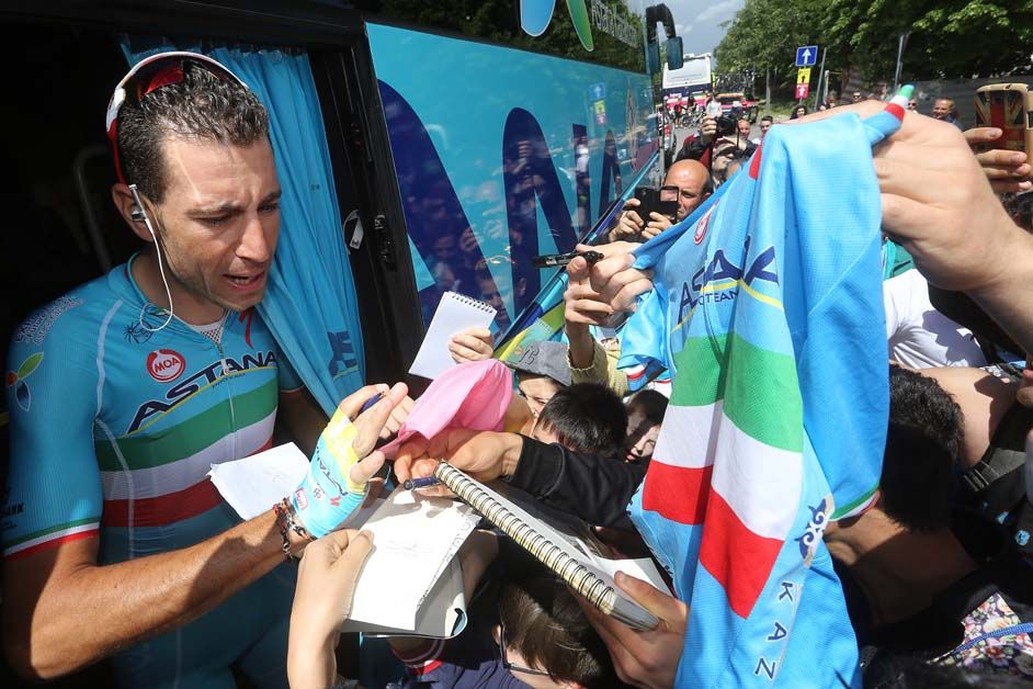 Italian champion Vincenzo Nibali is mobbed outside the Astana team bus