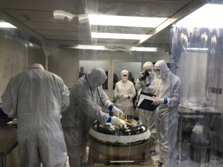 Practice clean room session at Lockheed Martin facility near Denver with specialists partially disassembling the OSIRIS-REx return capsule.