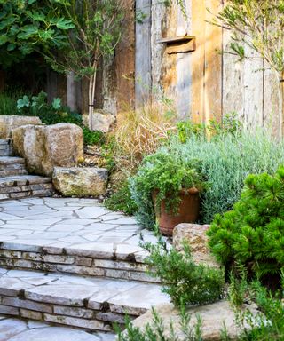 garden path made from local stone and rock boulders in coastal garden