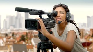 women holding the best camcorder on a tripod