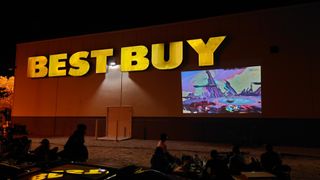 People play Super Smash Bros on a projector while waiting for Best Buy to open
