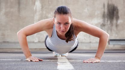 Woman performs burpee