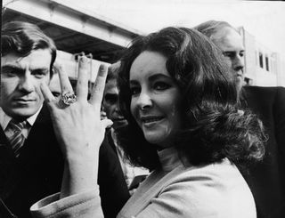 British-born actress Elizabeth Taylor shows off the 33.19 carat diamond ring given to her by husband Richard Burton.
