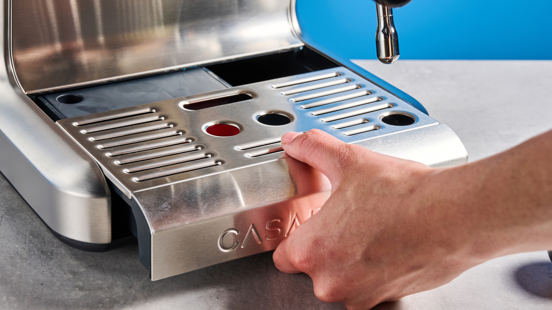the casabrews ultra espresso machine with 20 bar pressure, a steam wand, LED screen, timer, and tamper accessories, photographed against a blue background