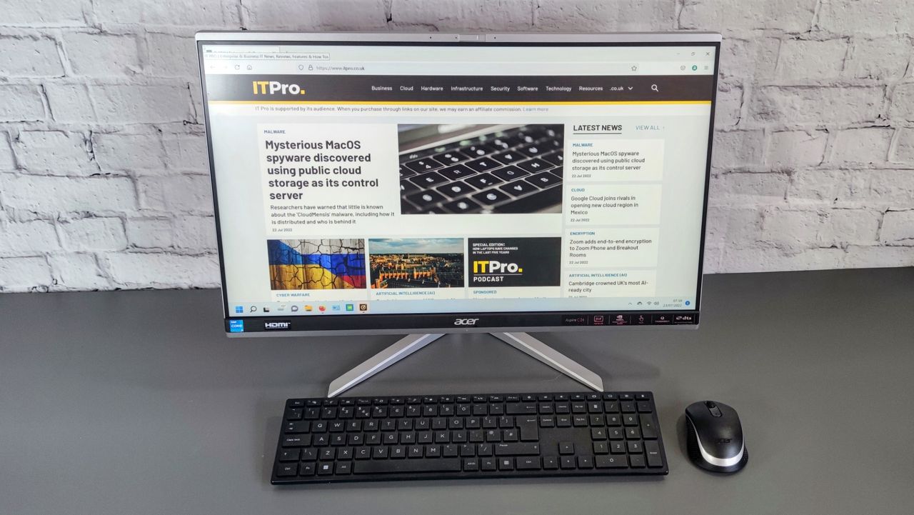 A photograph of the Acer Aspire C24 on a desk with mouse and keyboard