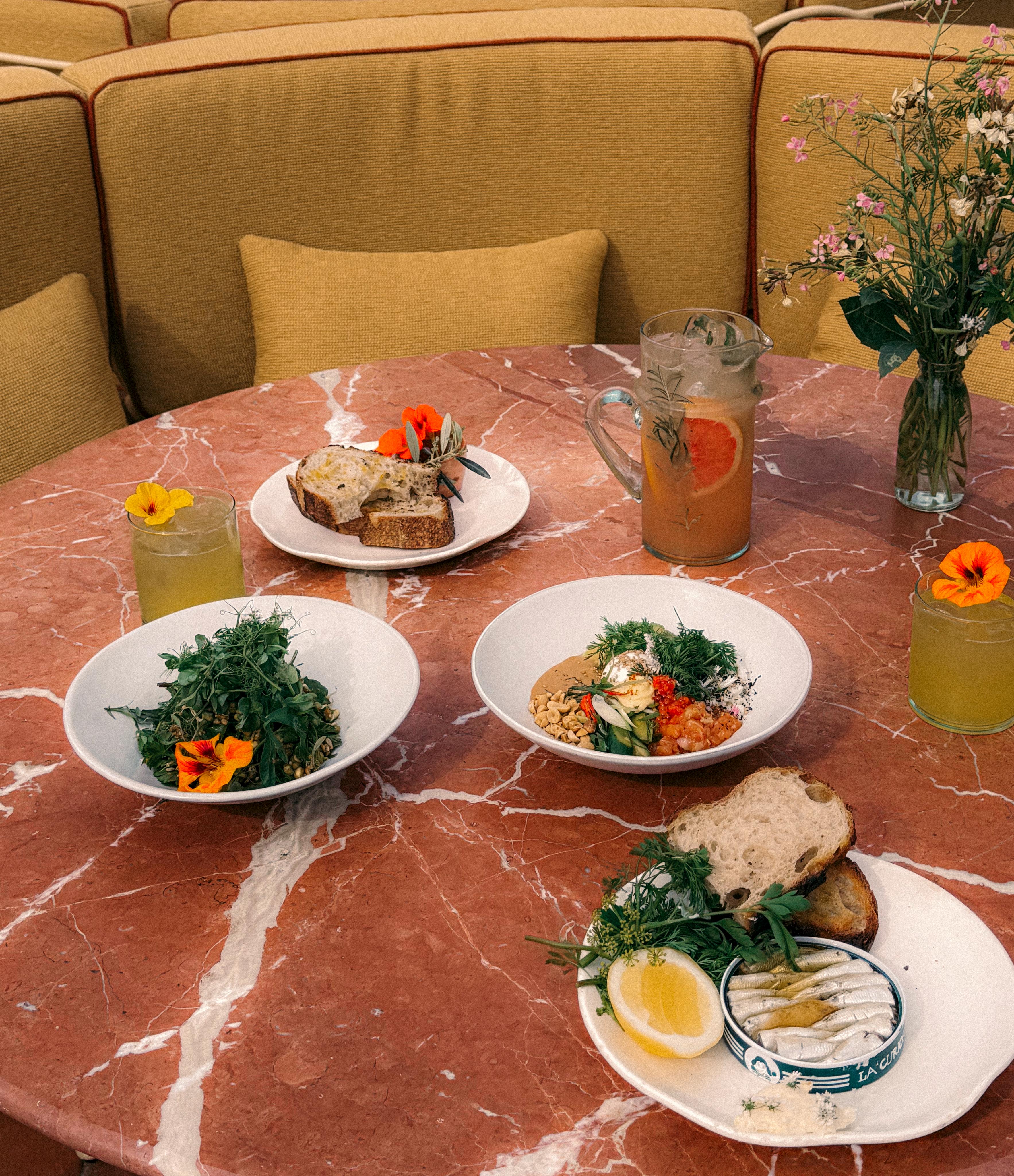 upholstered seating, tables and steel frame chairs on sunny terrace restaurant