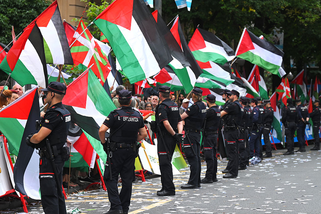 BILBAO, SPAIN - SEPTEMBER 03: Pro-Palestinian protesters at the finish line watched by the police (Ertzaina) during the La Vuelta - 80th Tour of Spain 2025, Stage 11 a 157.4km stage from Bilbao to Bilbao / Due to incidents at the finish line, the official times for the GC were taken at 3km from the finish line, there was no stage winner / #UCIWT / on September 03, 2025 in Bilbao, Spain. (Photo by Tim de Waele/Getty Images)