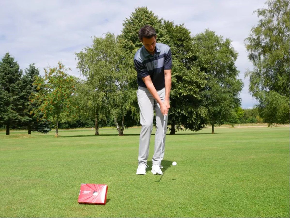 A golfer hits a pitch shot with the Callaway Chrome Soft