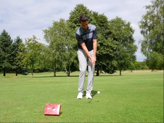 A golfer hits a pitch shot with the Callaway Chrome Soft
