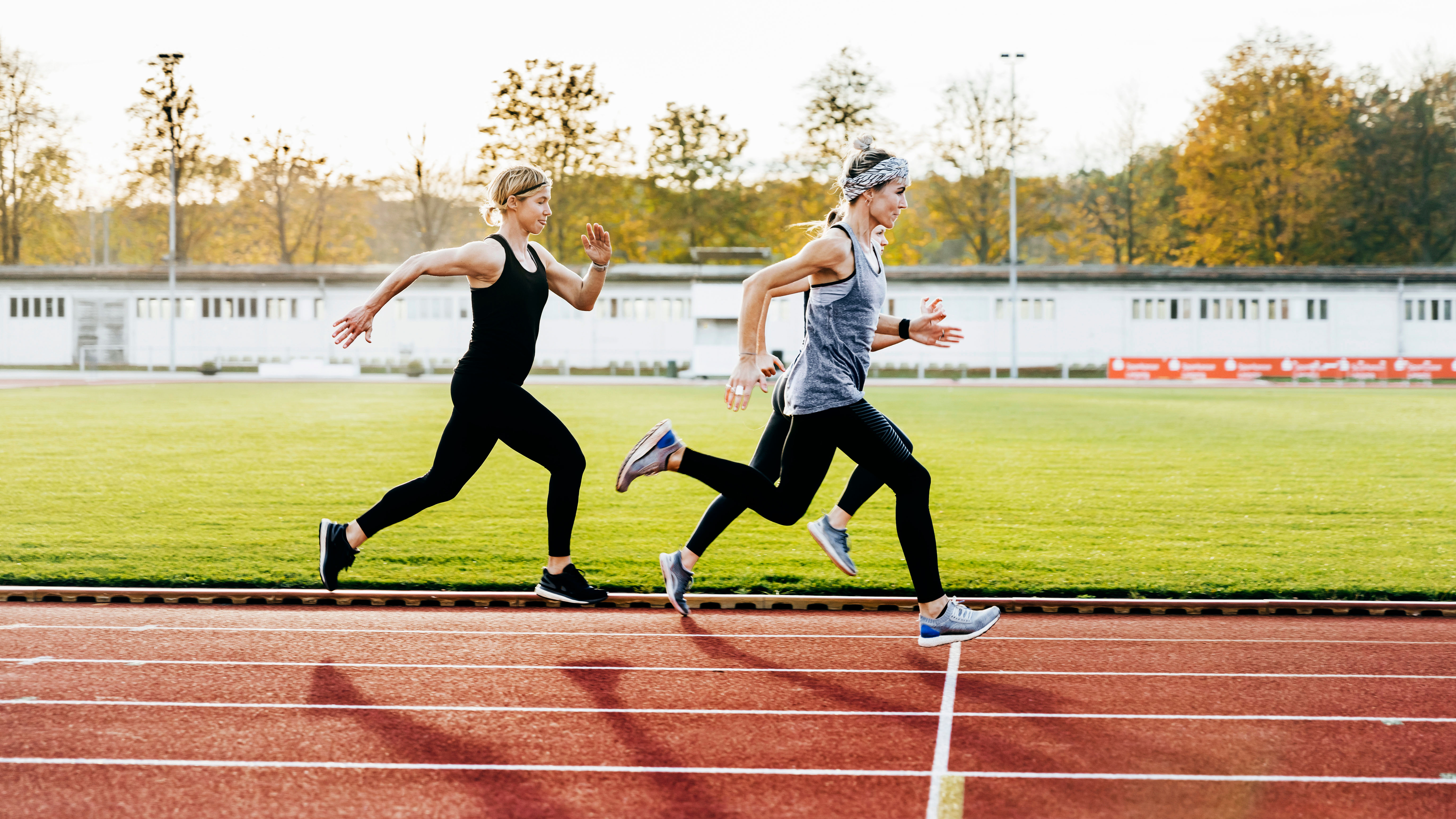 Three women running on track