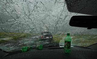 All in a day's work: Softball sized hail smashed a van's windshield during a storm chase during last year's VORTEX2 mission.
