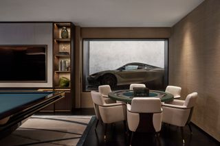 Stone and beige themed gaming room with car, tv, pool table and gaming table