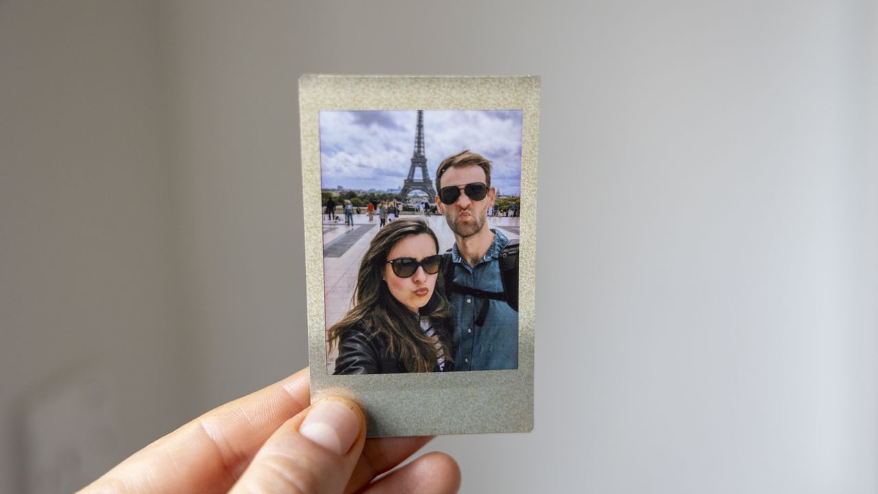 An Instax Mini featuring a couple in Paris