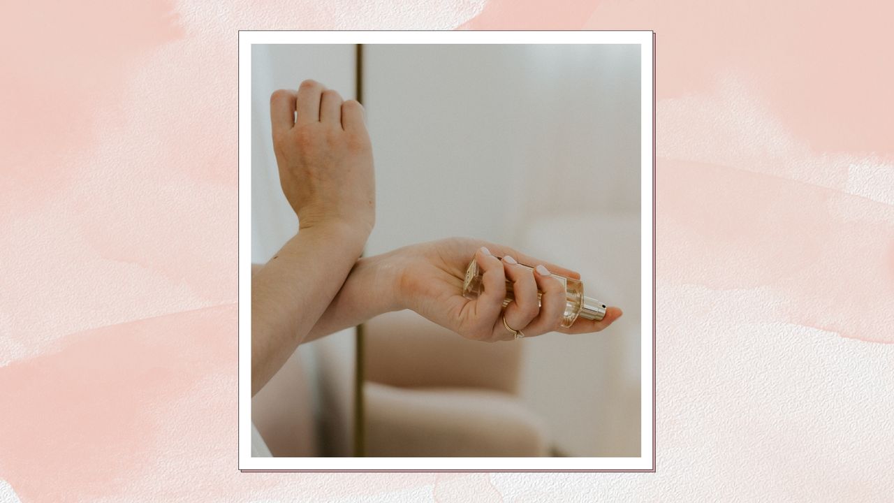 A close up of someone holding a glass bottle of perfume and rubbing their wrists together, as if they&#039;ve just sprayed them with the perfume/ in a pink/peach watercolour template