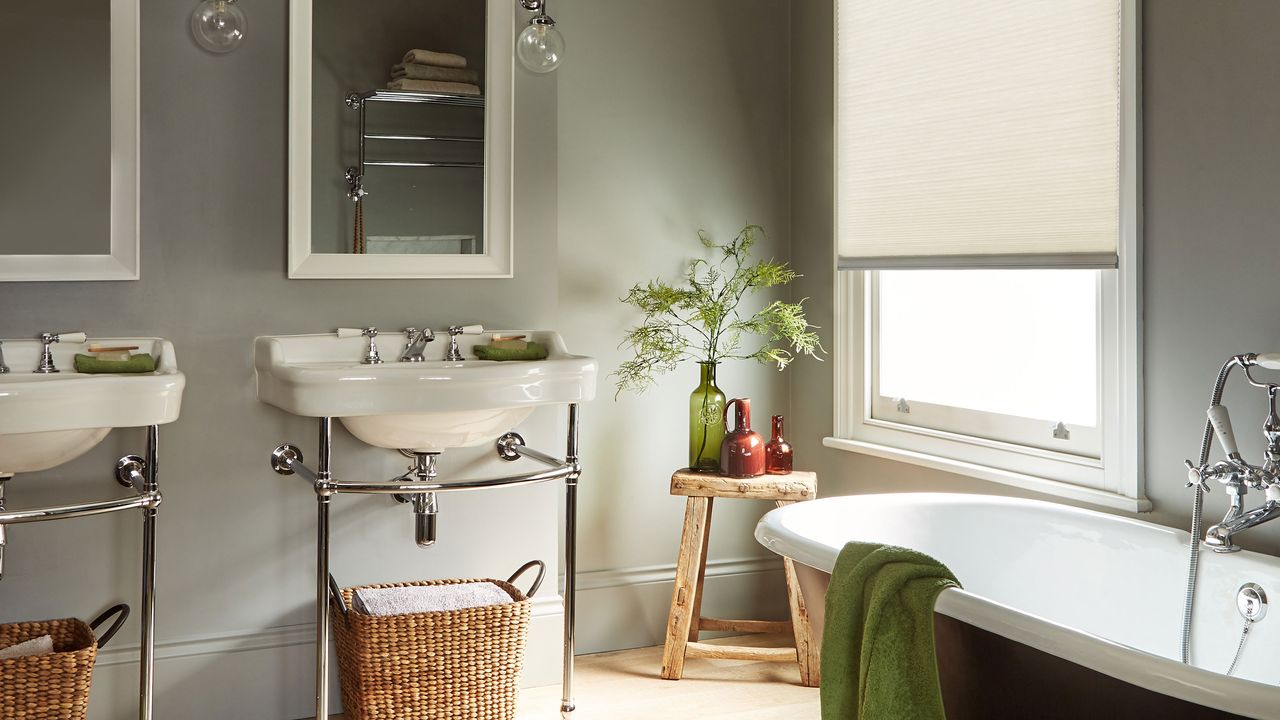 bathroom with two sinks and mirrors, and a bathtub