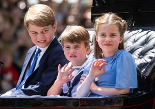 Prince George, Princess Charlotte, and Prince Louis ride in the carriage procession at Trooping the Colour
