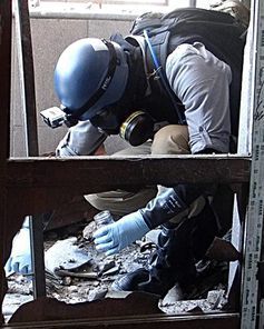 A UN weapons inspector collecting samples in August.