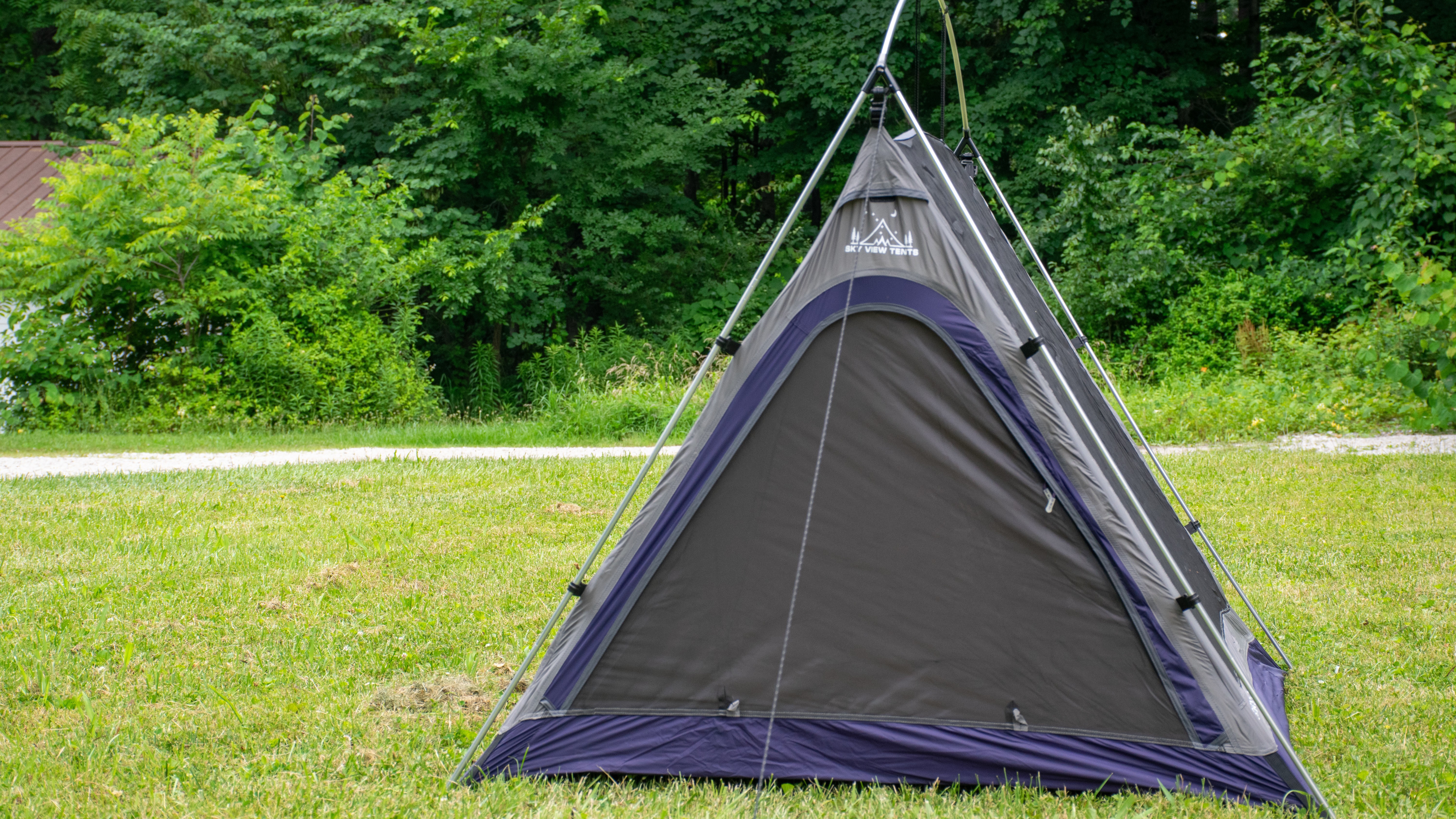 A tent sits on some grass.