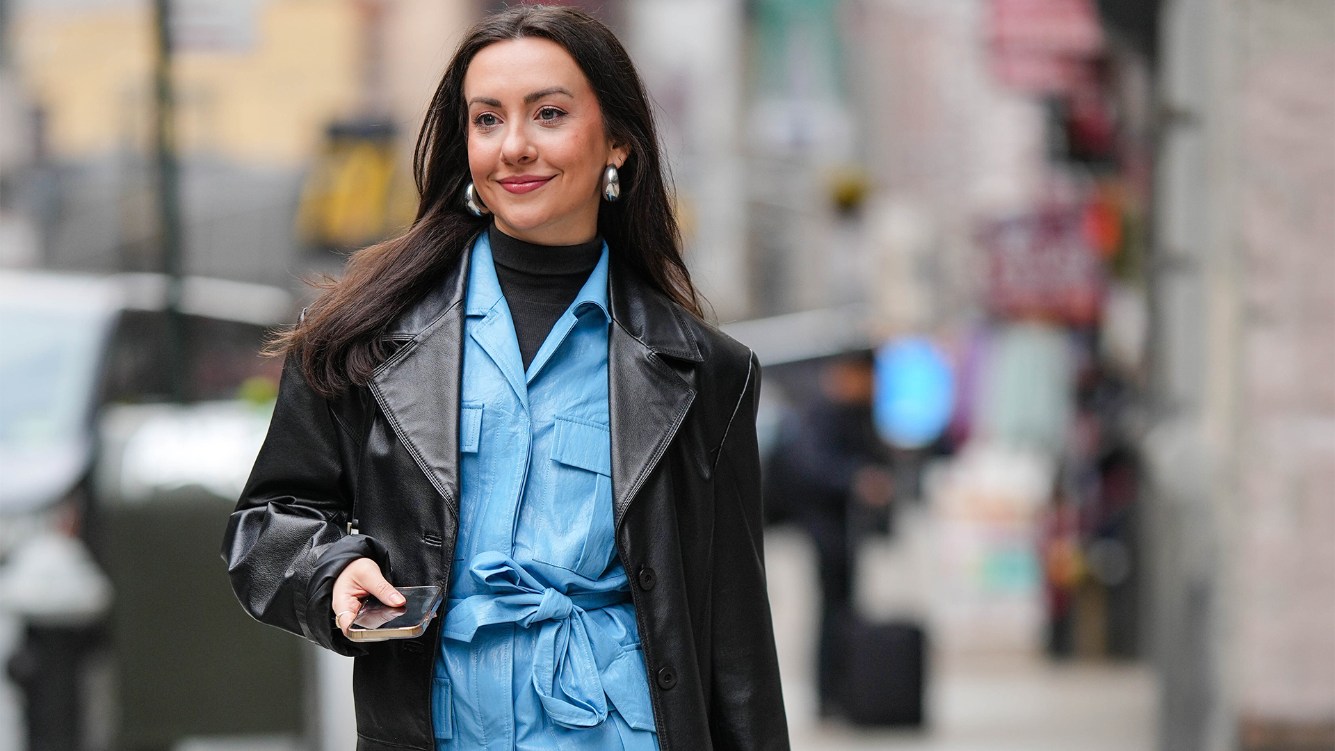 kendall wears blue leather set with long black boots with a black leather jacket over the blue set