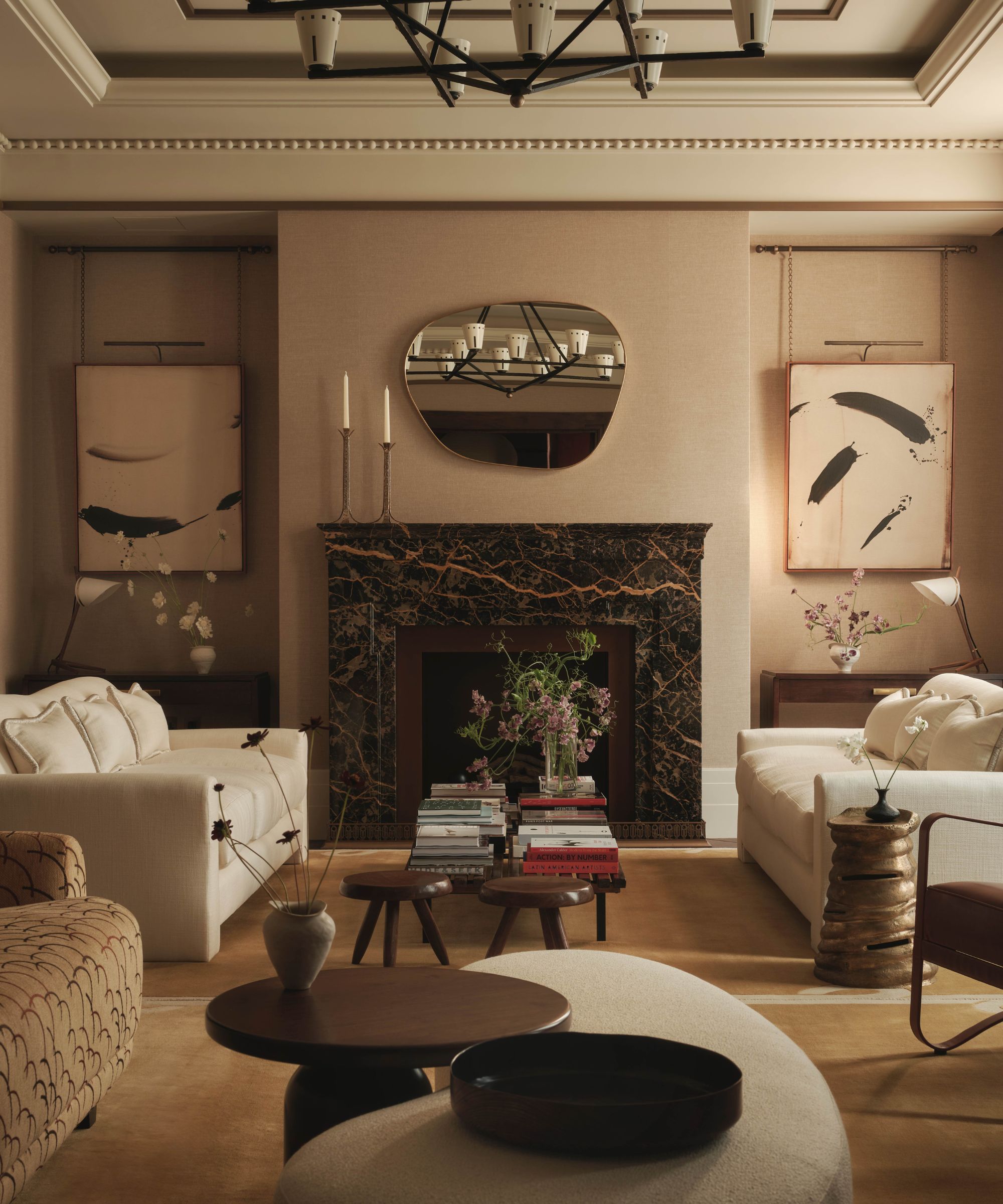 Light living room with a neutral color scheme and a large dark stone fireplace