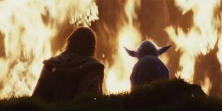 Luke Skywalker sitting with Force ghost Yoda