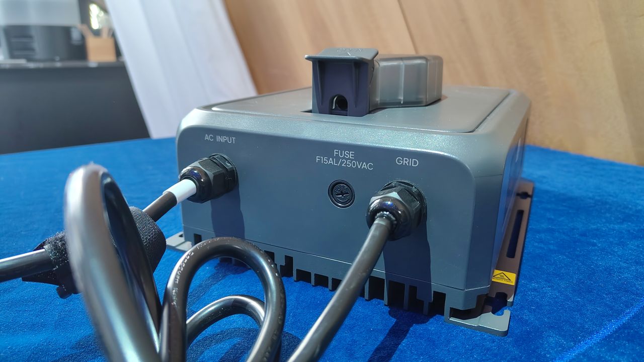 A Bluetti Transfer Hub on display on a table with a blue tablecloth